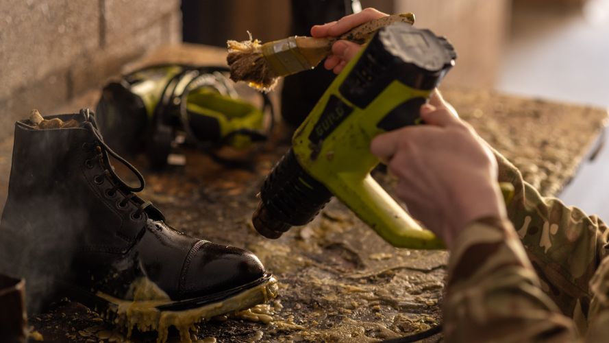 A member of the Grenadier Guards prepares parade boots using melted Bees-wax 16092022 CREDIT MOD Crown Copyright.jpg