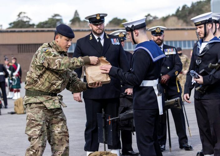 Support team hands out lunches to Royal Navy members as they wait at Pirbright before heading to London for a full dress rehearsal for Prince Philip's funeral (Picture: MOD).