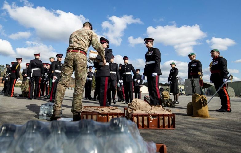Lunches are handed out to members of the Armed Forces in Pirbright as they wait to go to London for a full dress rehearsal for the Duke of Edinburgh's funeral (Picture: MOD).