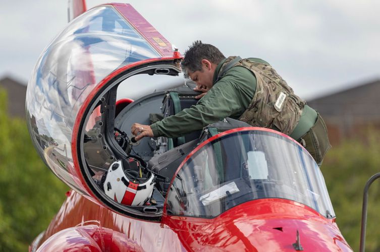 A new member of the RAF Red Arrows looking at the cockpit at RAF Scampton