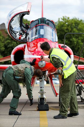 A new pilot flying for the Red Arrows checking over an aircraft at RAF Scampton 