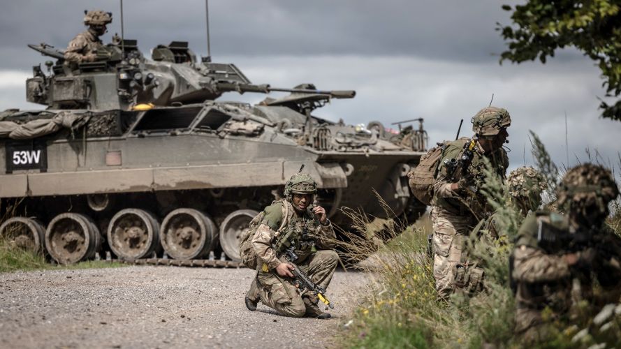 A section of Infantry soldier's attack a wood with a Warrior vehicle in support during Exercise IRON CYCLONE 28072023 CREDIT MOD.jpg