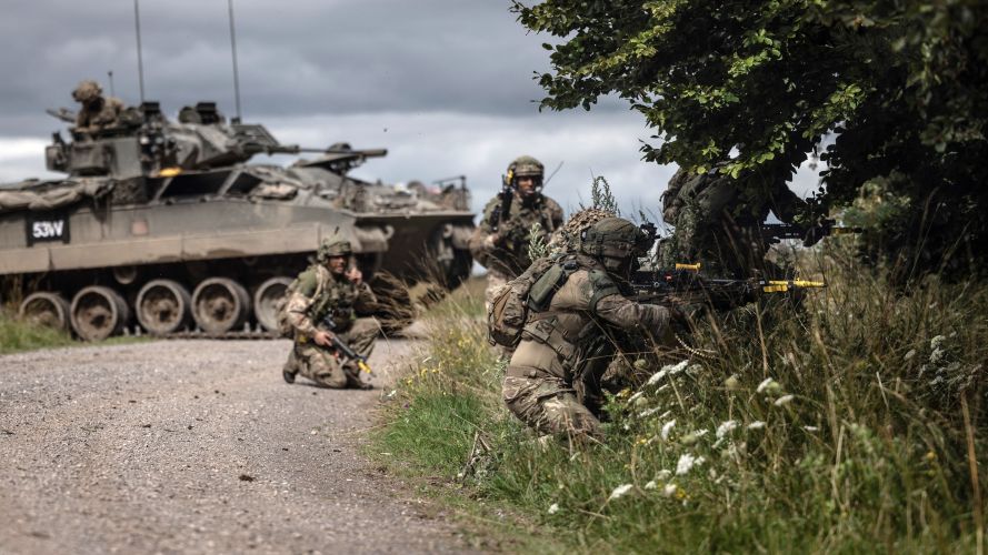 A section of Infantry soldier's attack a wood with a Warrior vehicle in support, Exercise IRON CYCLONE 28072023 CREDIT MOD.jpg