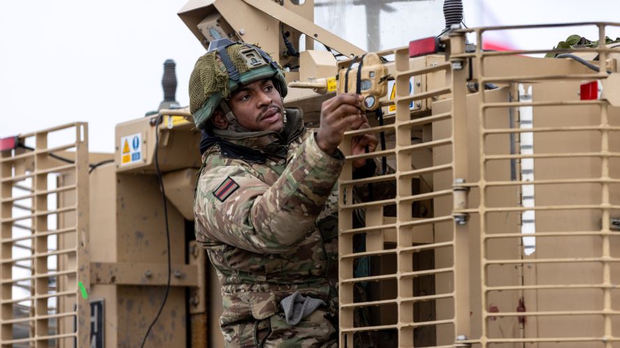 A soldier within 5 Rifles adjusts a Tactical Engagement Simulation (TES) sensor on the back of the Mastiff 22012023 CREDIT MOD Crown Copyright.jpg