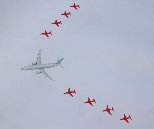 An incredible view of the Red Arrows flanking a Poseidon aircraft in a joint air display over Scotland (Picture: MOD).