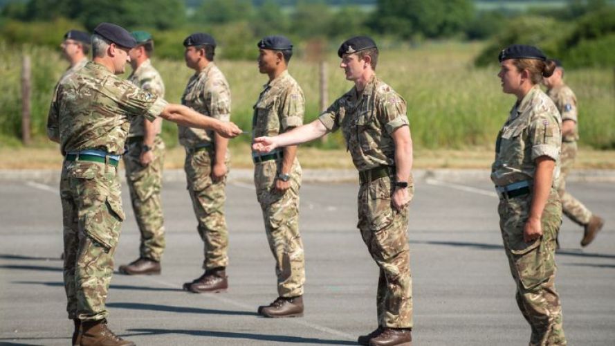 Badges 13th Signal Regiment being handed out on (Picture: MOD).