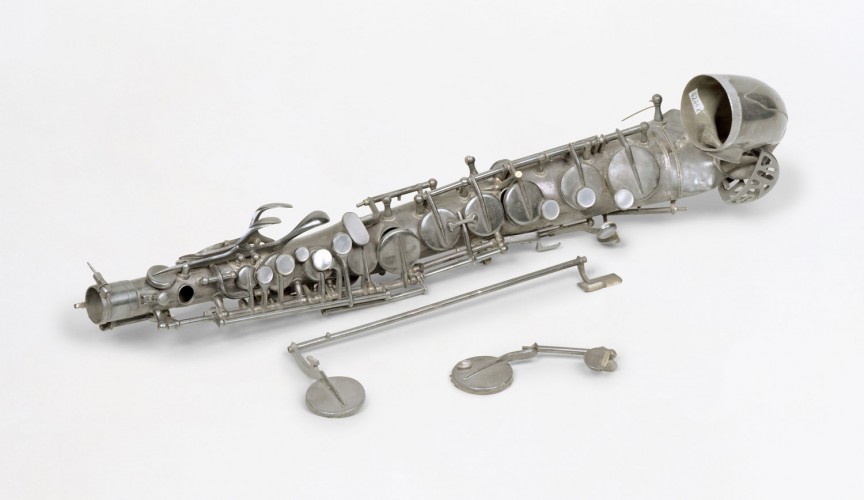 Silvered brass alto saxophone in E sharp. Only the bell with two valves is preserved.
