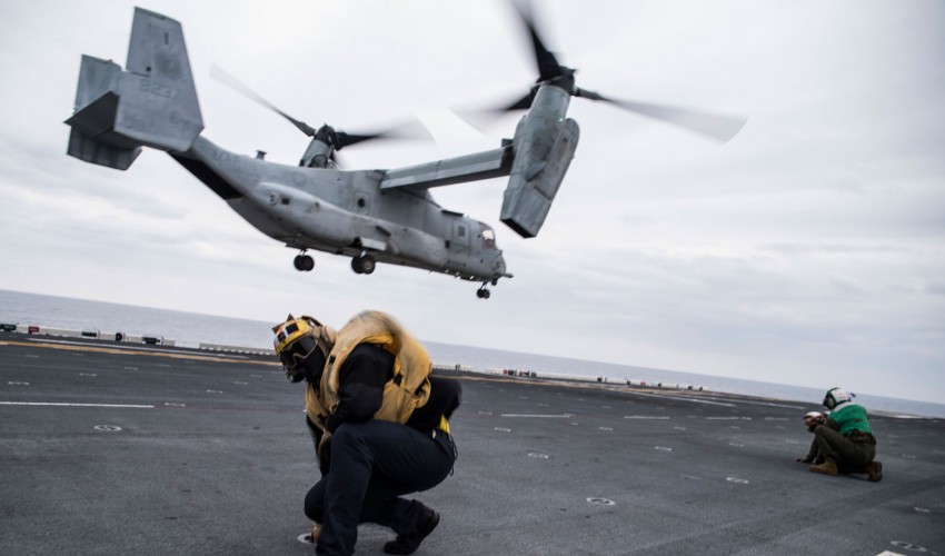 Aviation Boatswain's Mate Braces Against Rotor Wash 
