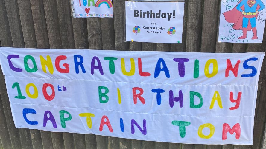 Children and adults have been celebrating Captain Tom Moore's birthday in his village displaying signs and cards.