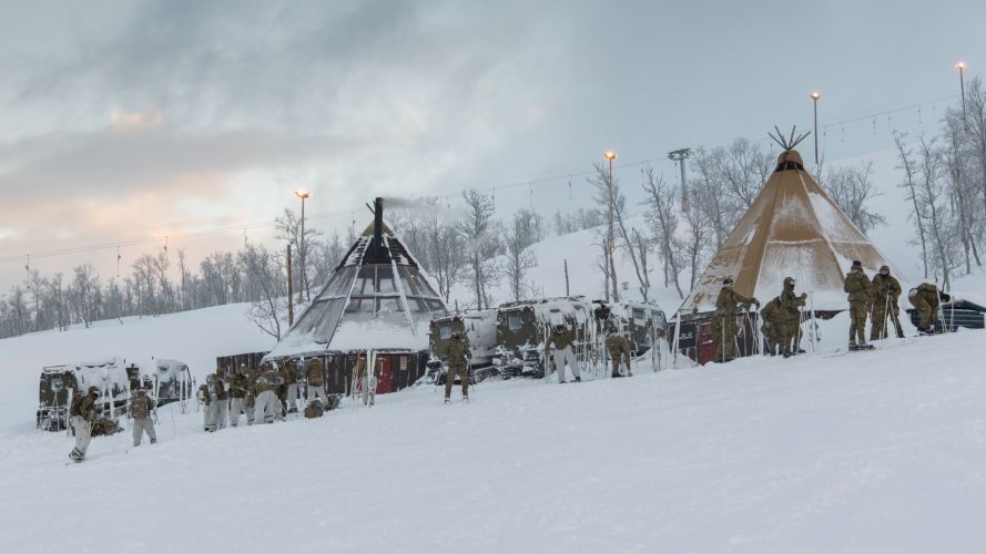Marines at their base camp, with Viking armoured personnel vehicles in the background