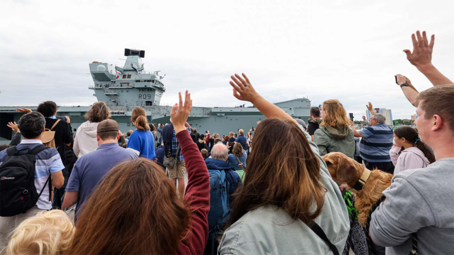 Families and friends waving as Royal Navy's biggest warship arrived at home port 