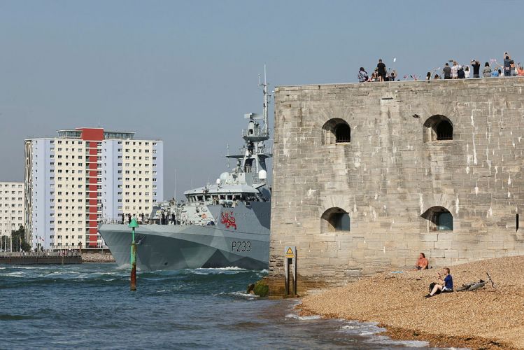 Families watch HMS TAMAR as she leaves HMNB Portsmouth and passes the Round Tower to be forward deployed in the Indo-Pacific Region
