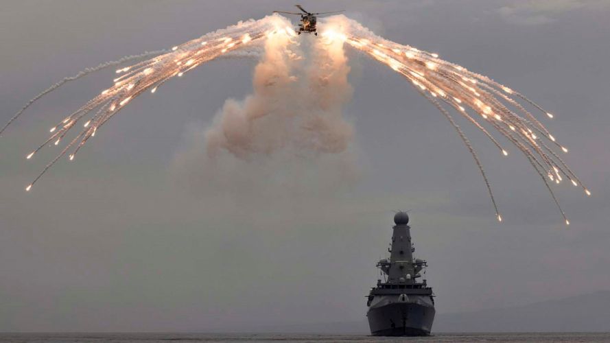 Wildcat fires flares alongside HMS Defender during deployment with CSG21 (Picture: Royal Navy). Flare firing by a British military Wildcat with HMS Defender during deployment with CSG21 21062021 Credit Navy.jpg