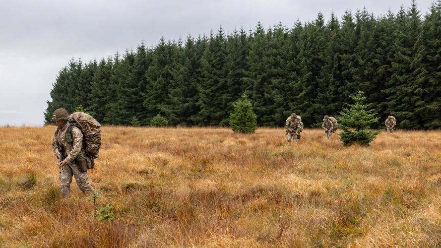 Fully ladden soldiers moving across open ground during Exercise Cambian Patrol 111024 CREDIT MOD