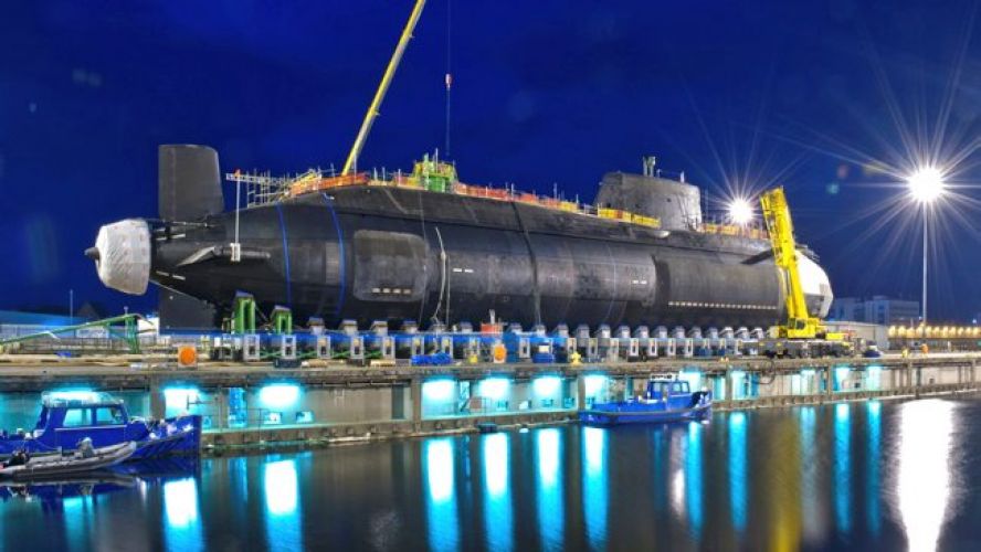 HMS Artful, the Royal Navy's third Astute Class nuclear submarine, being lowered into the water at Barrow-in-Furness, Cumbria