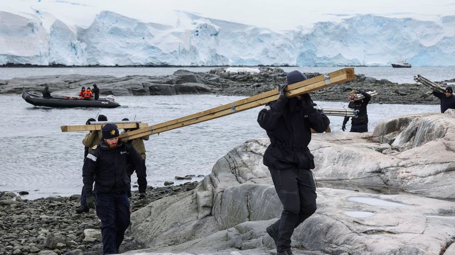 HMS Protector restocking UK Antarctic Heritage Trust at Port Lockroy near nesting Gentoo penguins 25012022 CREDIT HMS Protector Twitter.jpeg