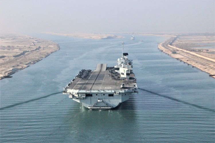 HMS Queen Elizabeth passed through the Suez Canal in Egypt on Carrier Strike Deployment in July (Picture: HMS QE Twitter). HMS Queen Elizabeth passes through the Suez Canal in Egypt on Carrier Strike Deployment 060721 CREDIT HMS Queen Elizabeth Twitter.jpg