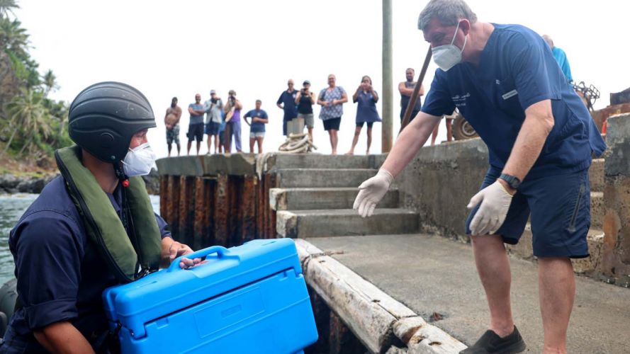 A sailor delivers COVID-19 vaccines 