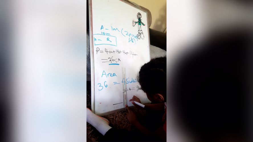 Child drawing on whiteboard