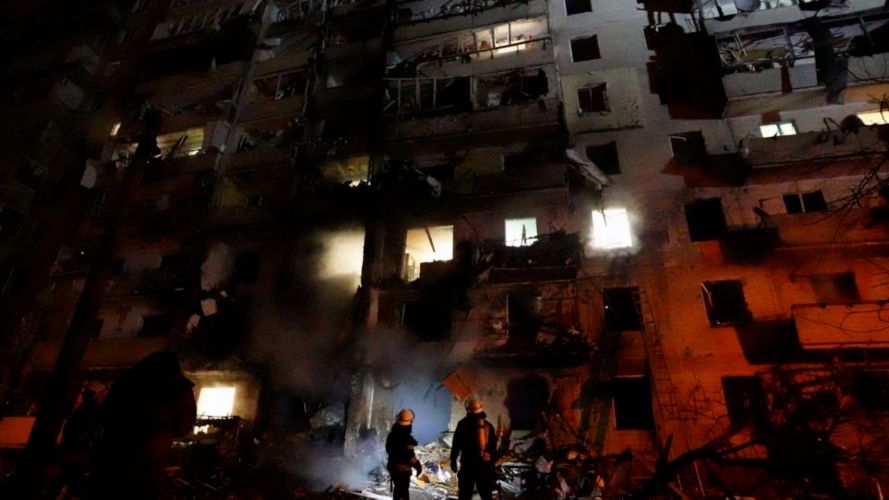 Ukrainian firefighters respond to the a rocket attack on a residential building attacked by Russian military forces