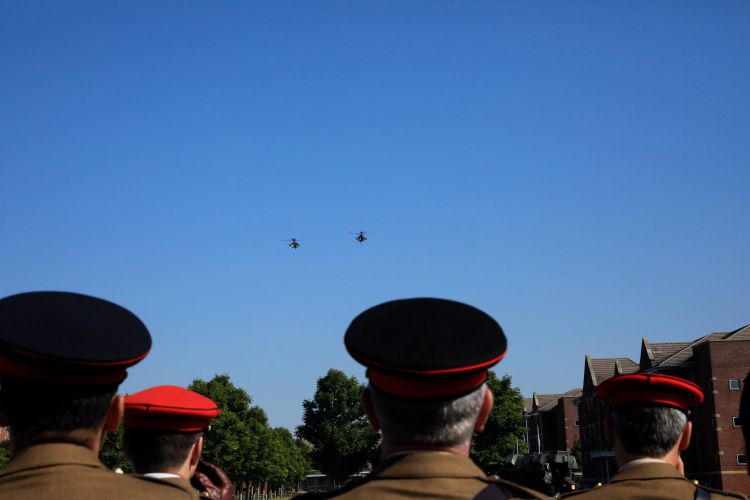 Junior soldiers look overhead at a flypast to mark their graduation from AFC Harrogate.