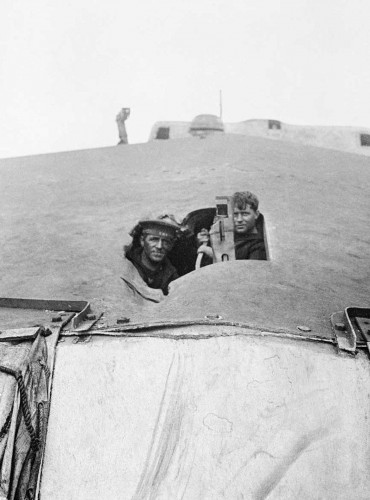 © IWM (SP 1597) Two sailors looking through a shell hole in the forward turret roof of the battlecruiser HMS TIGER. Overall she was hit fifteen times by large calibre shells during the battle of Jutland and lost twenty four members of her crew killed and a further forty six wounded.
