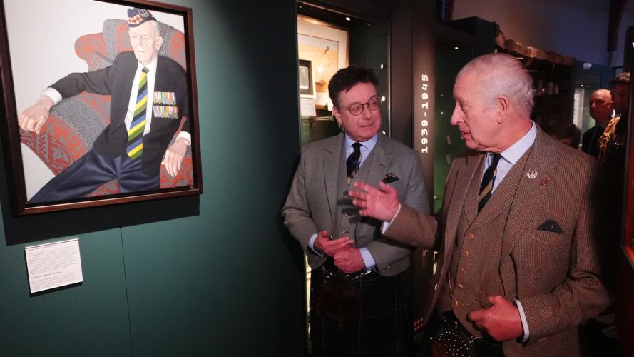 King Charles III is shown a painting of 99-year-old D-Day veteran Jim Glennie CREDIT PA.jpg