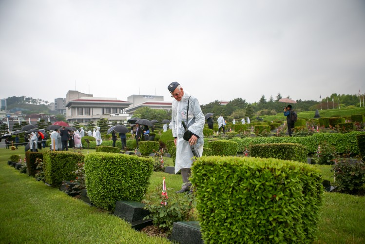 Korea Revisit Veterans UN Cemetery Laying Roses Graves