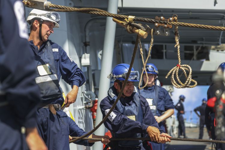 Lines are pulled across as HMS Kent conducts a replenishment at sea (RAS) with RFA Fort Victoria whilst in the Indo-Pacific region 20210818 Credit MOD Crown Copyright.jpg
