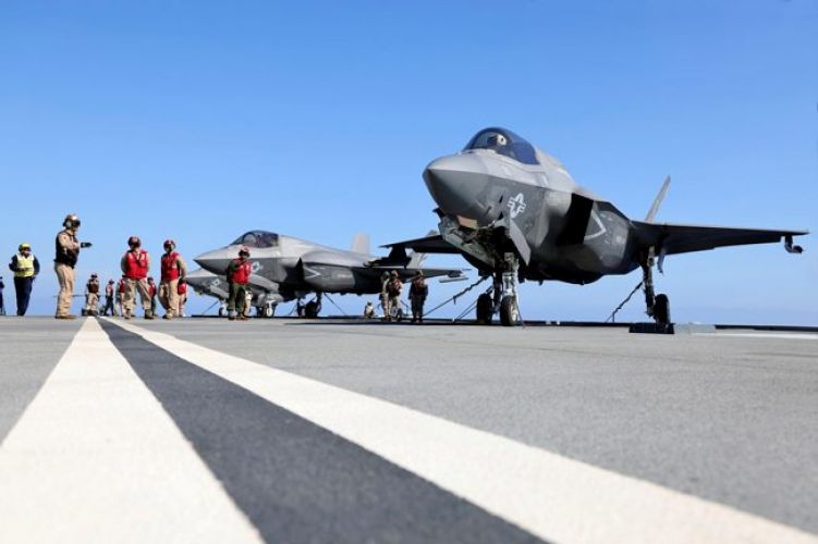 Members of VFMA-211 prepare an F35B Lightning Jet for a launch from HMS Queen Elizabeth