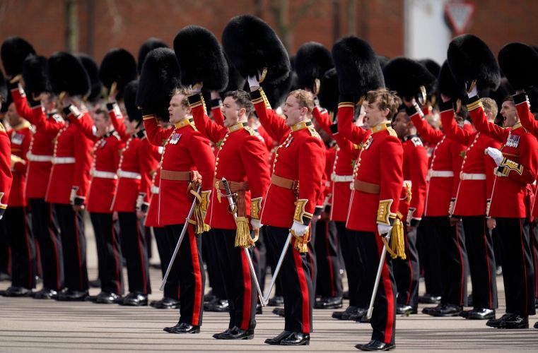 Members of the Irish Guards give three cheers to the Duke and Duchess of Cambridge during their visit to the 1st Battalion Irish Guards for the St Patrick's Day Parade