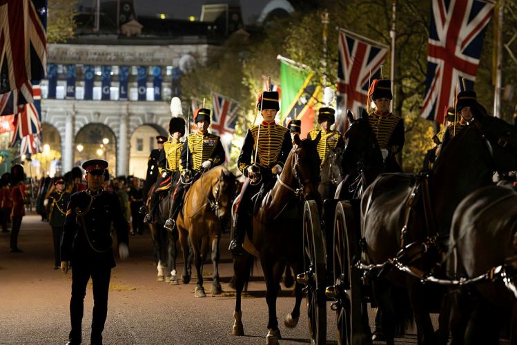 Military personnel carrying out the final full rehearsal of the Coronation at night in London