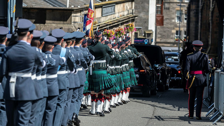 Military personnel lead a procession along Edinburgh’s Royal Mile on the occasion of the Presentation of the Honours of Scotland to The King and Queen