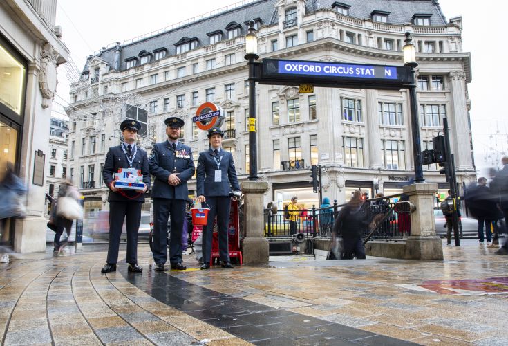 Military personnel standing outside Oxford Circus tube station to fundraise for London Poppy Appeal 