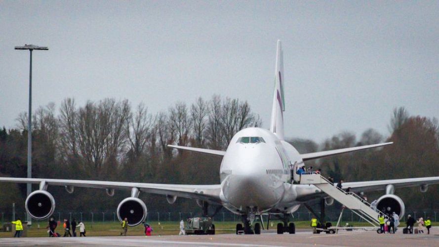People wearing facemasks disembark from an aircraft repatriating British and other nationalities to the UK from the coronavirus-hit city of Wuhan in China, following its arrival at RAF Brize Norton (Picture: PA).