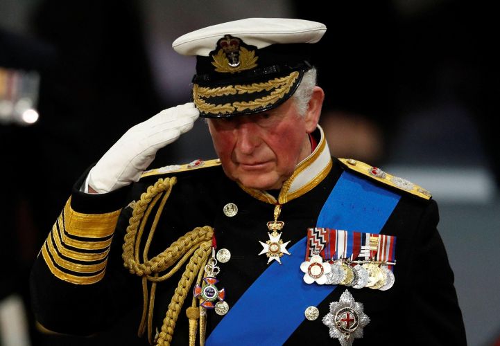 Prince Charles in uniform salutes during HMS Prince of Wales commissioning ceremony at Portsmouth naval base in December 2019 (Picture: Alamy).