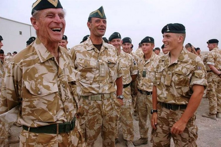 The Duke of Edinburgh shares a joke with the Commanding Officer and soldiers of the Queen's Royal Hussars Battle Group at Basra Air Station in Iraq, October 2006.
