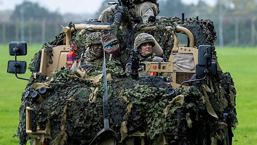 Princess of Wales arrives at a military display stand in the passenger seat of a Jackal Armoured vehicle