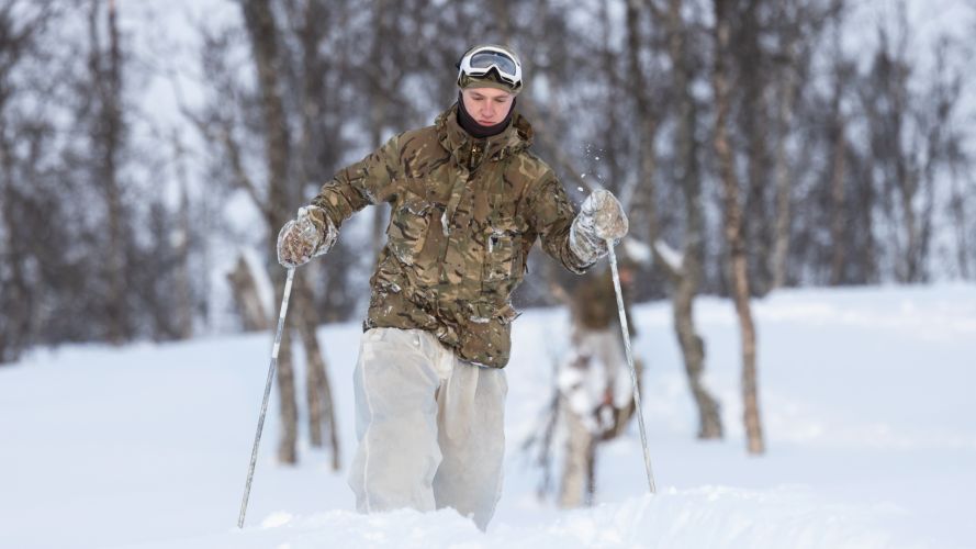 Royal Marine Commando skiing through the trees during the Cold Weather Winter Warfare Course at Malselv