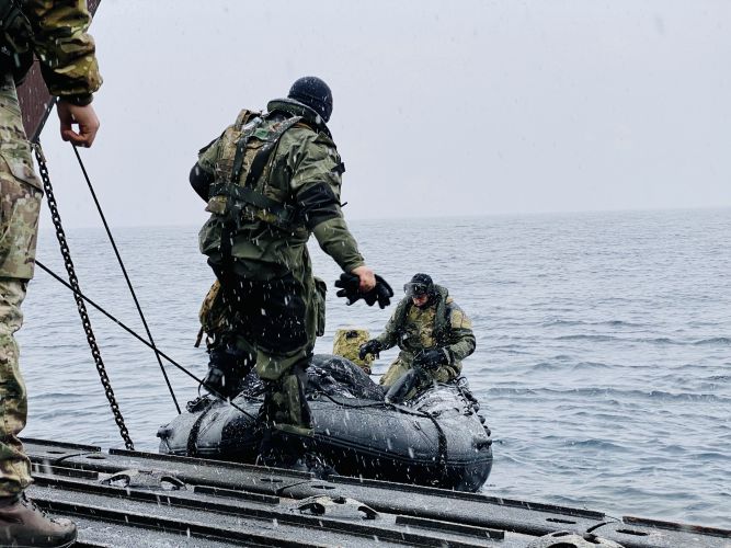 Royal Marine Commandos deploying from a landing craft whilst on NATO's Exercise Cold Response 