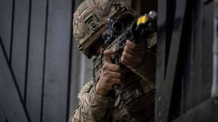 Soldier in a fire position on an urban assault during Exercise Iron Cyclone