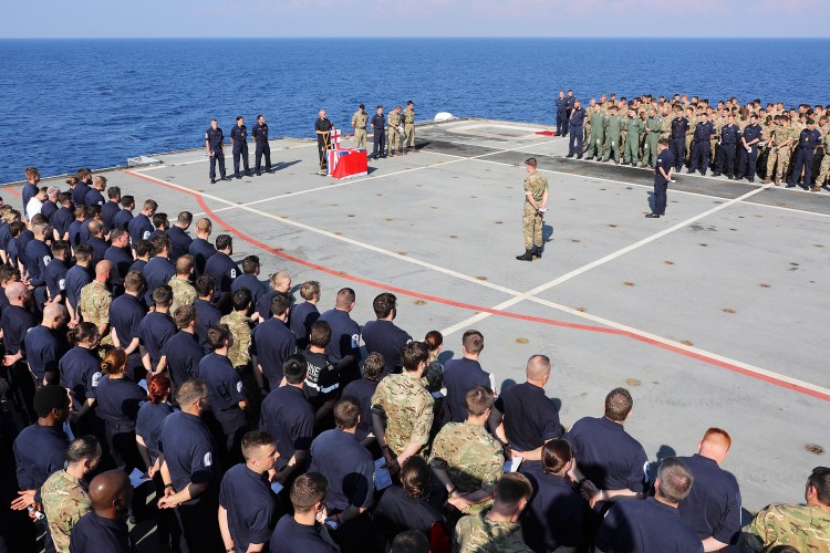 HMS Ocean ships company and NATO partners stand shoulder to shoulder during the Remembrance service onboard HMS Ocean. (Picture: MoD)