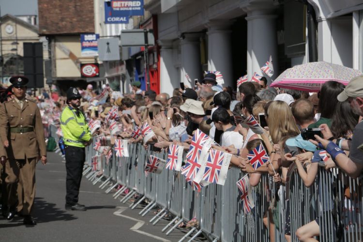 Anonymous hands holding Union flags British flags at Armed Forces Day