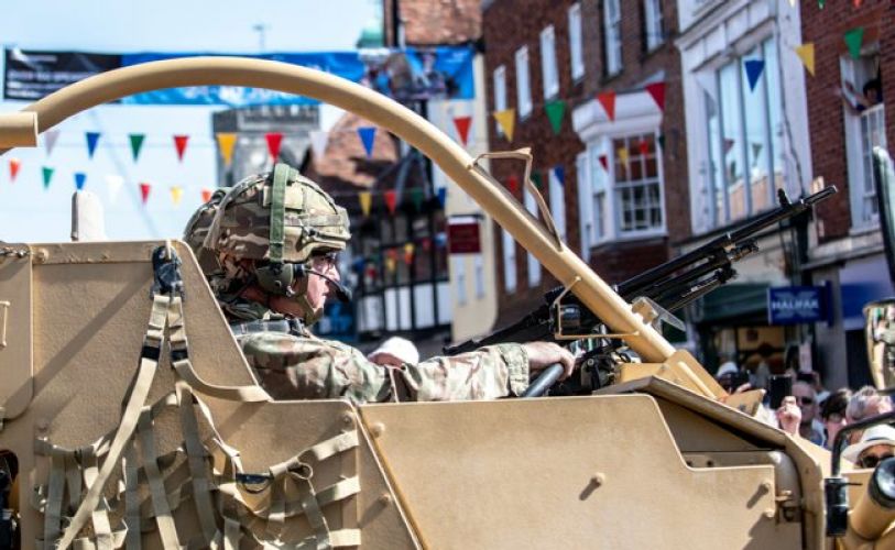 Soldier driving vehicle through Salisbury on Armed forces day 