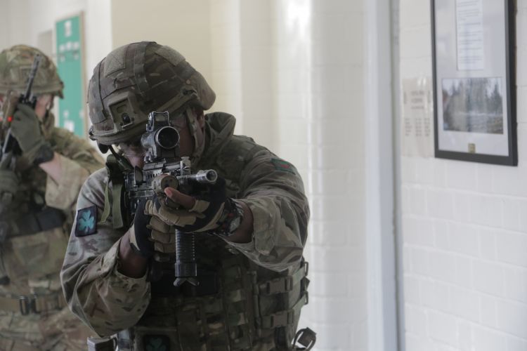 Soldier holds his weapon. 