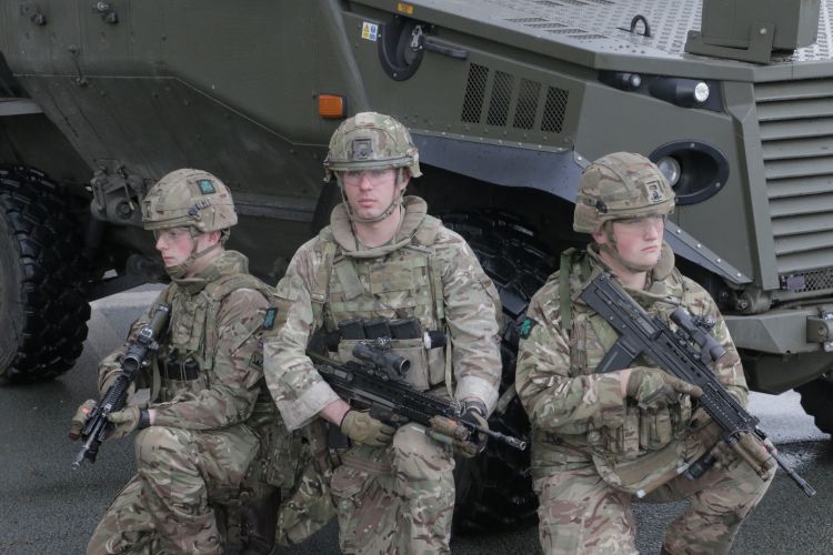 1st Battalion soldiers pose in front of a Foxhound.