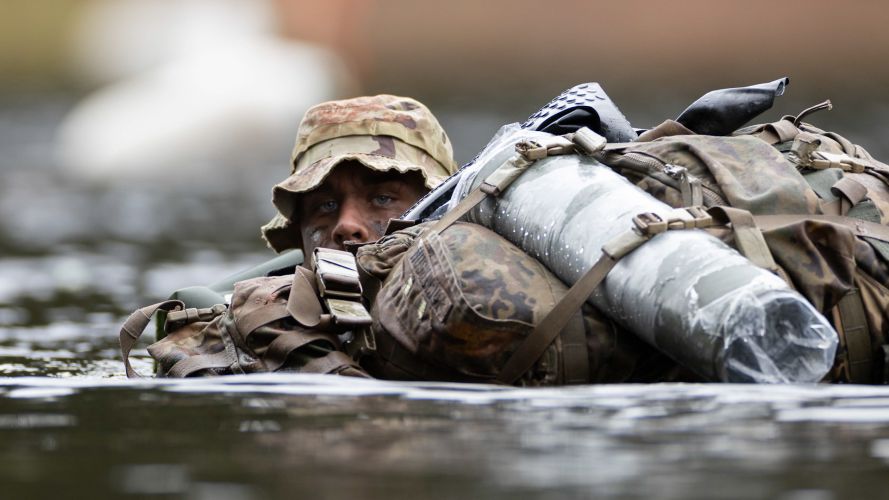 Soldiers from The United States Army carry out a river crossing during Exercise Cambian Patrol