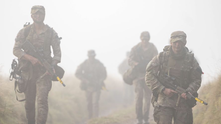 Soldiers from the Royal Military Police patrol through the mist during Exercise Cambian Patrol 111024 CREDIT MOD