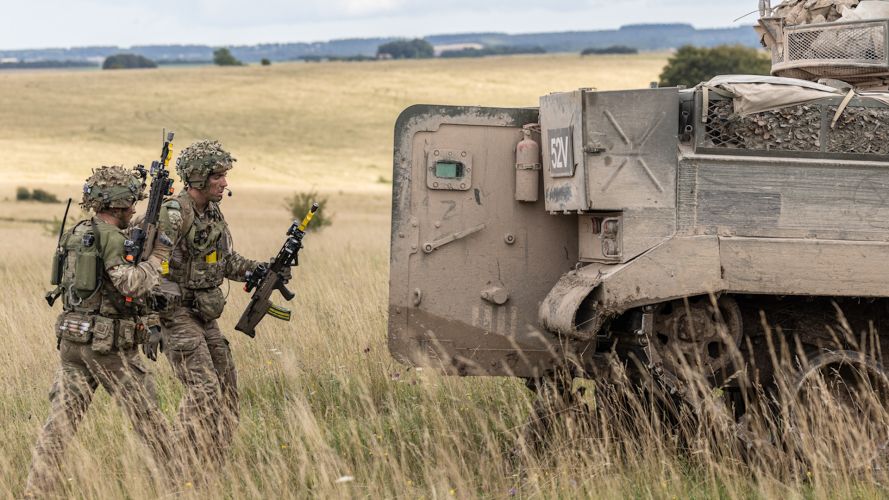 Soldiers mount back up into Warrior vehicles after clearing an enemy position EX IRON CYCLONE 25072023 CREDIT MOD