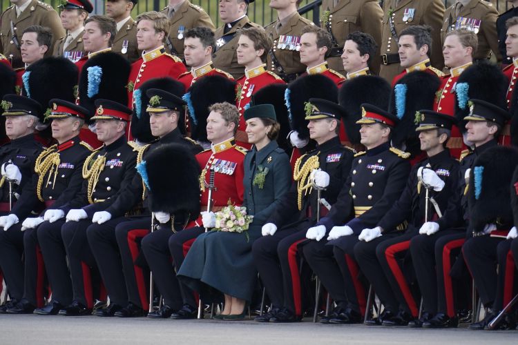 The Duke and Duchess of Cambridge sit for a group photo during their visit to 1st Battalion Irish Guards for the St Patrick's Day Parade, at Mons Barracks in Aldershot